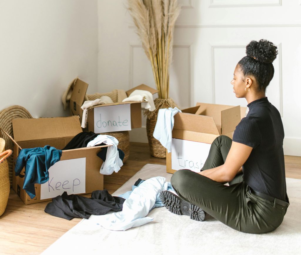 Woman Sitting on a Rug Sorting through boxes