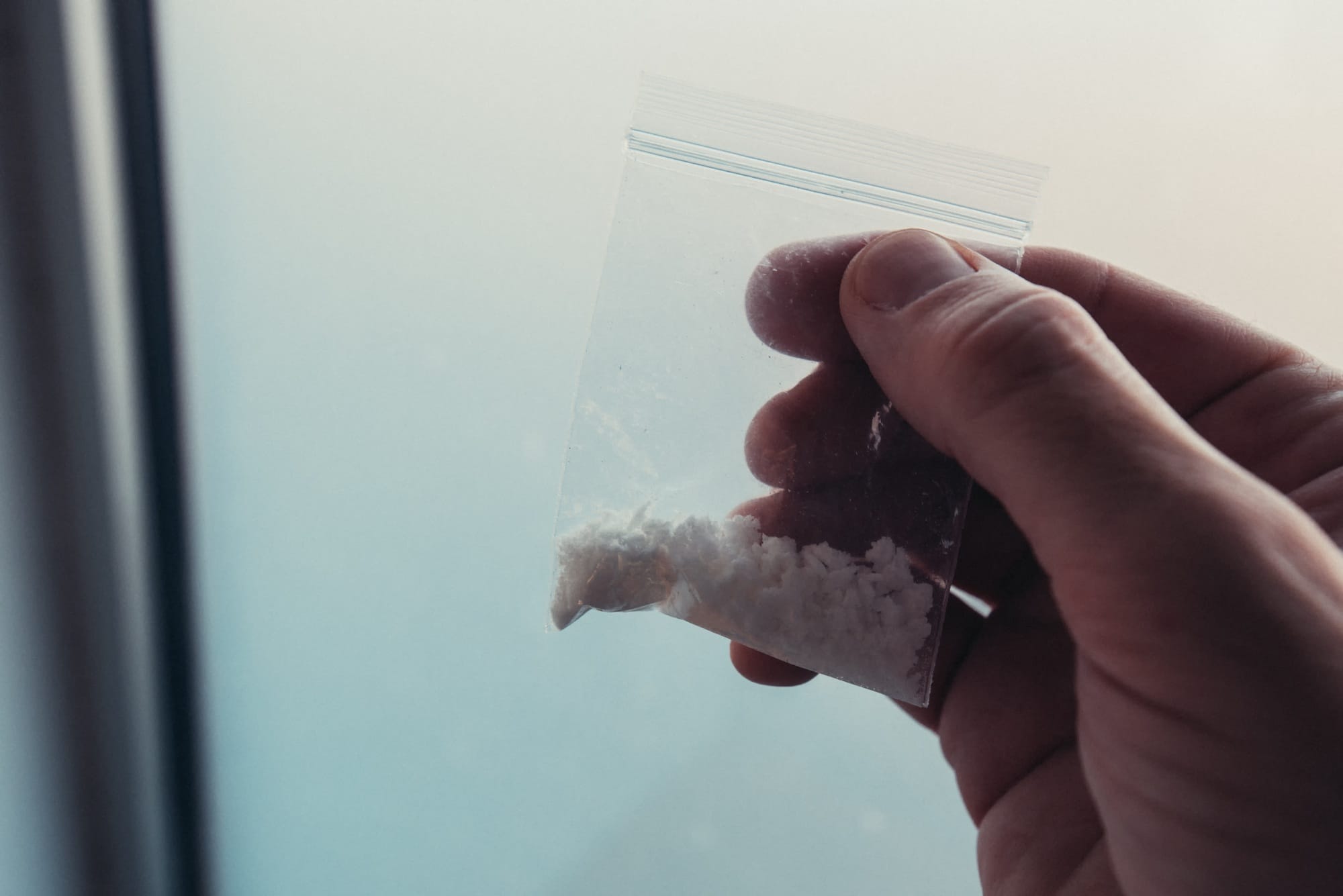 Criminology expert collecting drug evidence at crime scene