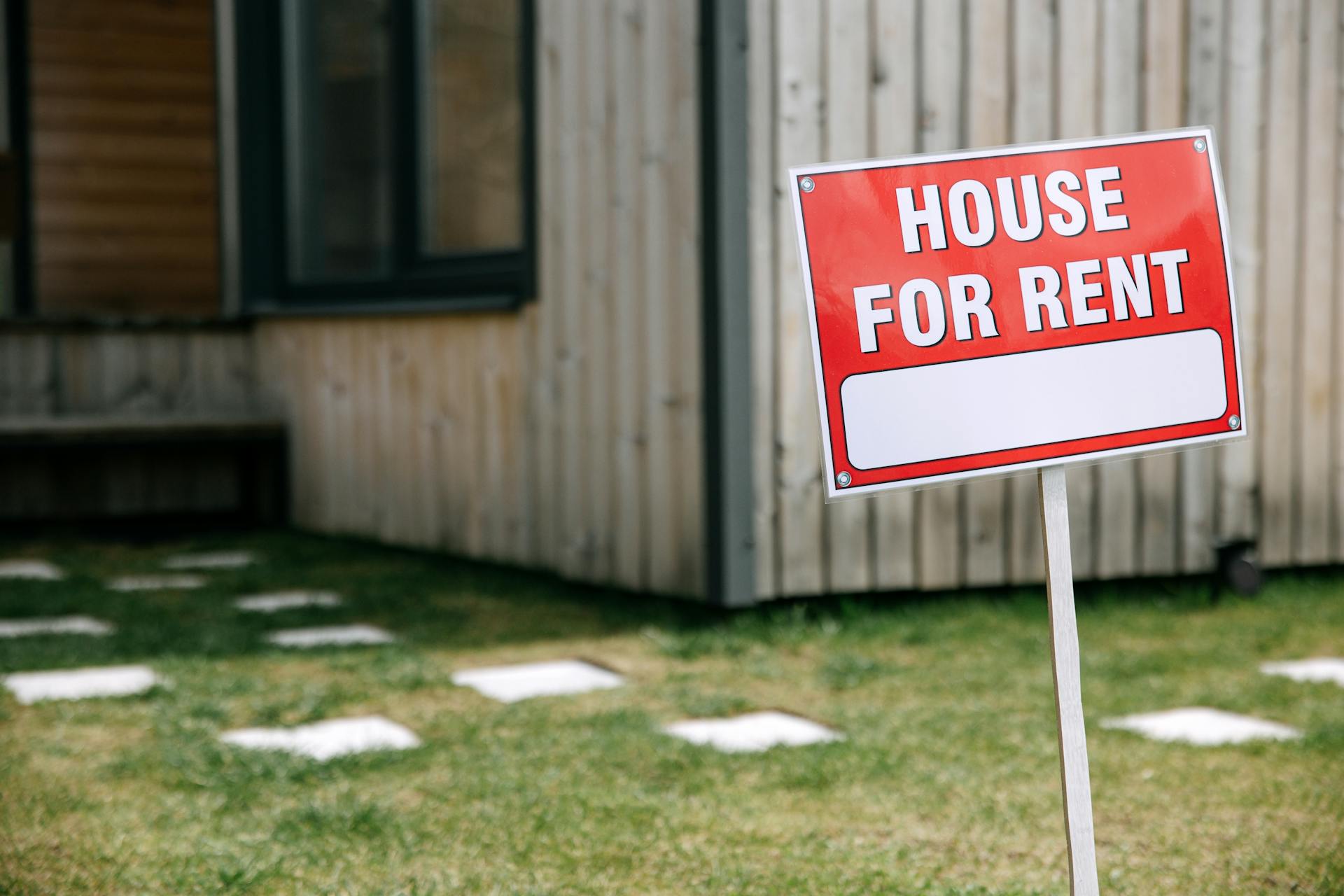 Sign indicating house available for rent.