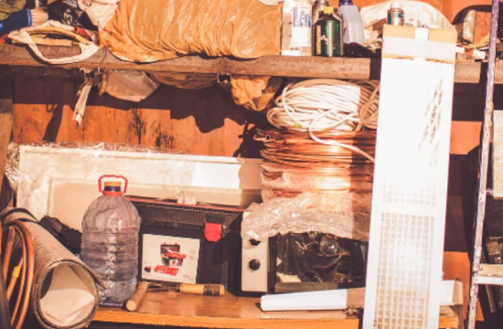 Cluttered shelf with various tools and items